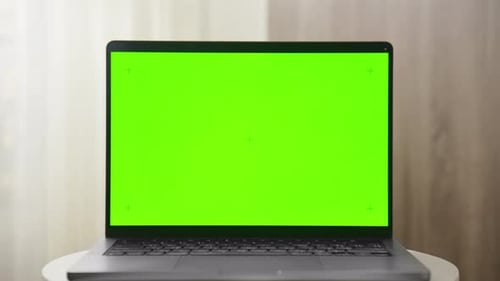 Laptop with Green Screen Mockup on Table