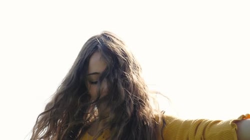 Young Woman Laughing and Posing in Sunny Weather