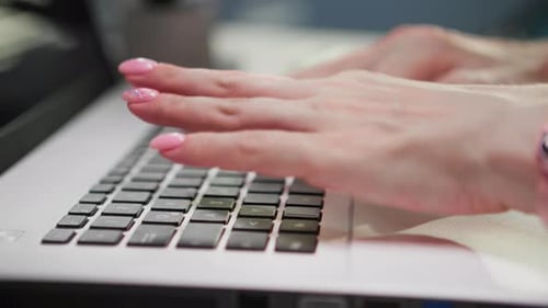 Woman's Hands Typing on Laptop Keyboard Close Up