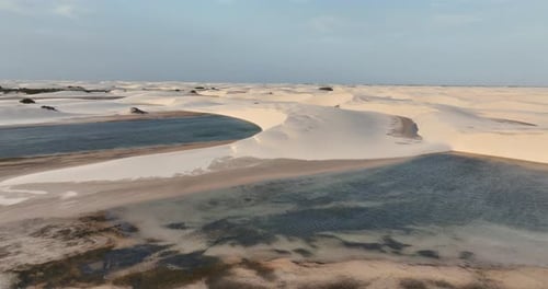 Aerial view of the Lencois Maranhenses desert, dunes and water pools under a clear sky