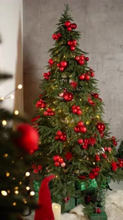 Christmas Tree with Red Decorations and Glowing Lights New Year Concept