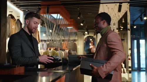 Black Man In Clothing Store Making Contactless Payment With Credit Card