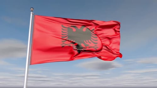 National Flag of Albania Waving Against Blue Sky