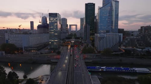 Aerial Footage of Traffic on and Under Bridge Near Modern Business Borough La Defense High Rise