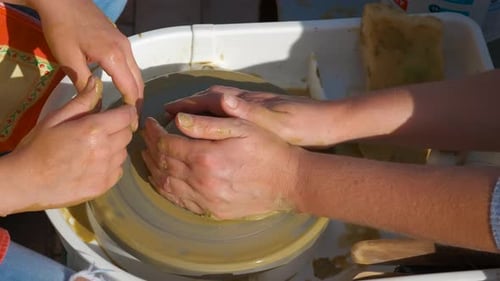 Child Learning How to Make Pottery