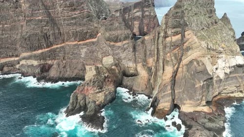 Aerial view of rugged cliffs and ocean waves, Portugal.