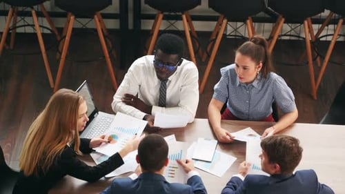 International Business Partners Discuss Financial Project Results on Meeting in Office Multiethnic