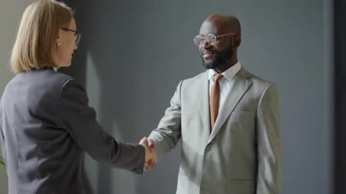 Businesspeople Shaking Hands After Successful Meeting