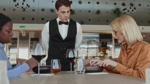 Waiter Listening Respectfully to Customer Complaint in Restaurant