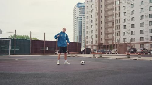 Man Warming Up Before Soccer Game in City