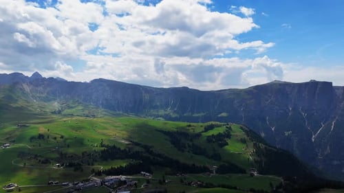 Moving clouds create dynamic shadows over stunning mountain scenery