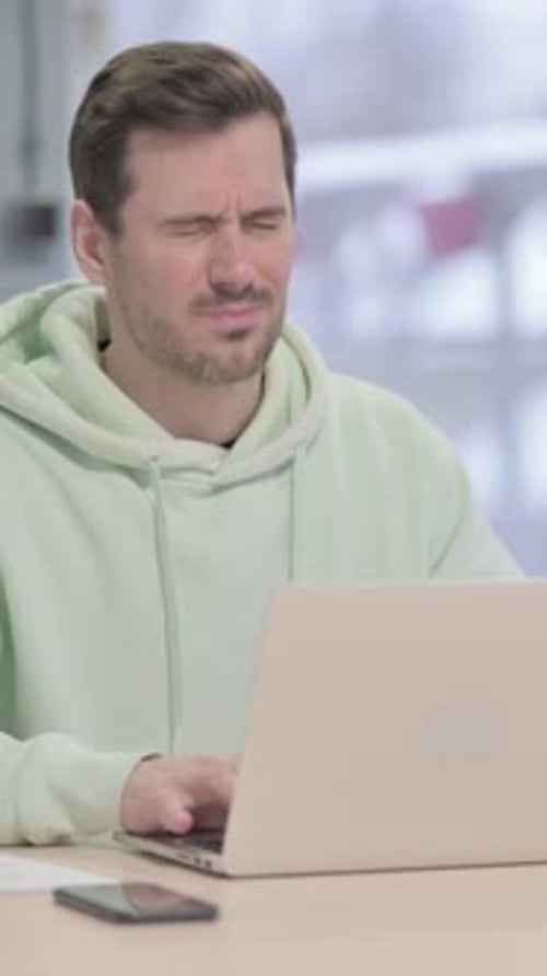 Man Working on Laptop Develops Neck Pain