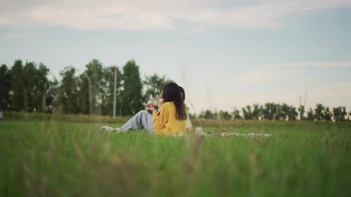 Lovers Watching Sunset Pair Enjoys Peaceful Dusk in Grassy Field Romantic Partners Relish Tranquil