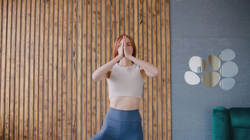 Woman Doing Yoga Tree Pose in Living Room