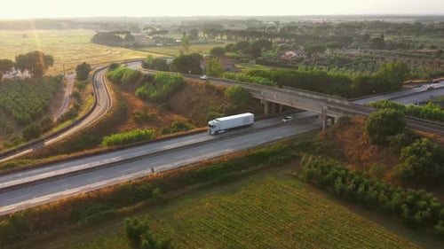 Aerial Drone Footage: Long Haul Semi Truck Driving on the Busy Highway in the Rural Region of Italy