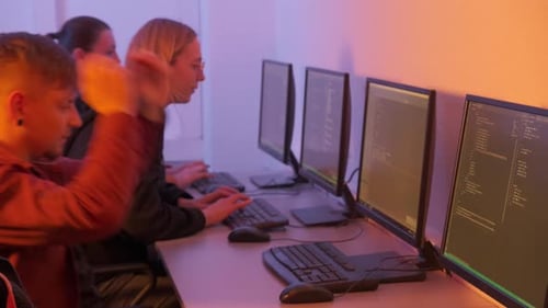 Young Adults Coding at Computers in Tech Office