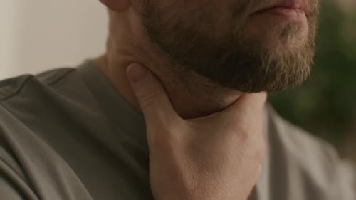Close Up of Man with Sore Throat Holding His Neck