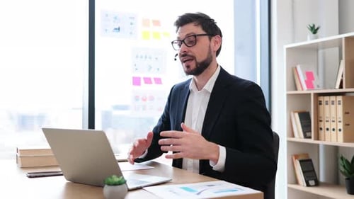 Businessman Engaged in Video Call in Office Setting