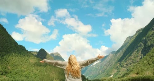 Freedom, carefree and enjoying mountain view after hiking, traveling and exploring remote Norway