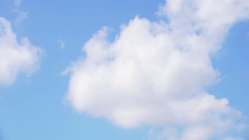 Fluffy Clouds Drifting in the Blue Sky