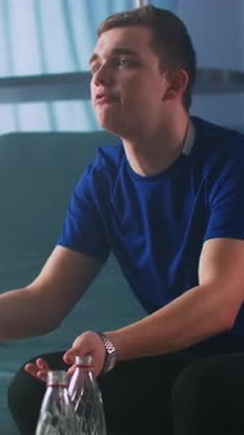 Figure In Blue Shirt Passionately Appeals As He Watches Critical Game Unfold On Television