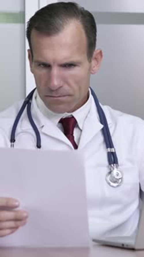 Doctor Working on Medical Documents in Clinic, Vertical Video