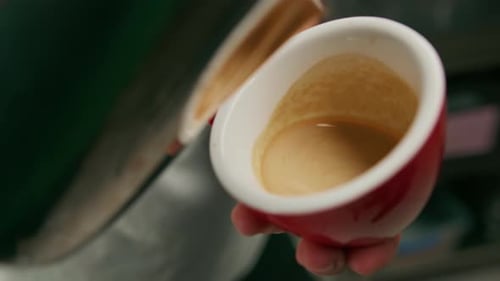 Barista making latte art in a cafe Male hands pouring steam of milk into a cup of Cappuccino