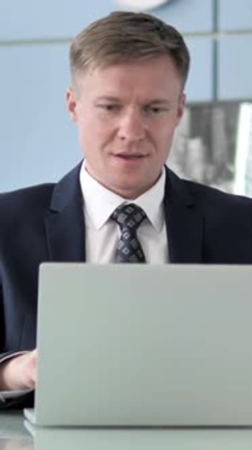 Excited Man Cheers While Looking at Laptop Screen