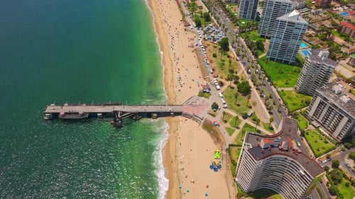 Aerial view of the Vergara Pier on a sunny day at El Sol Beach with clean sand and luxury