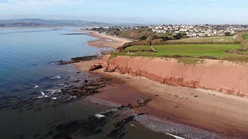 Aerial parallax shot of sandstone Jurassic Coast Cliffs at Exmouth Devon England