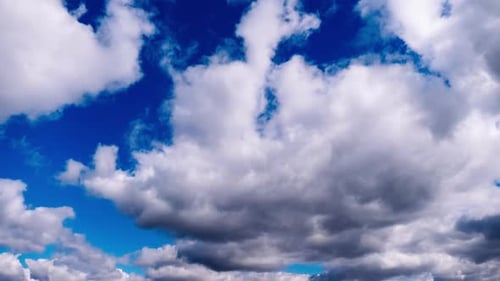 Clouds Float Across a Clear Blue Sky