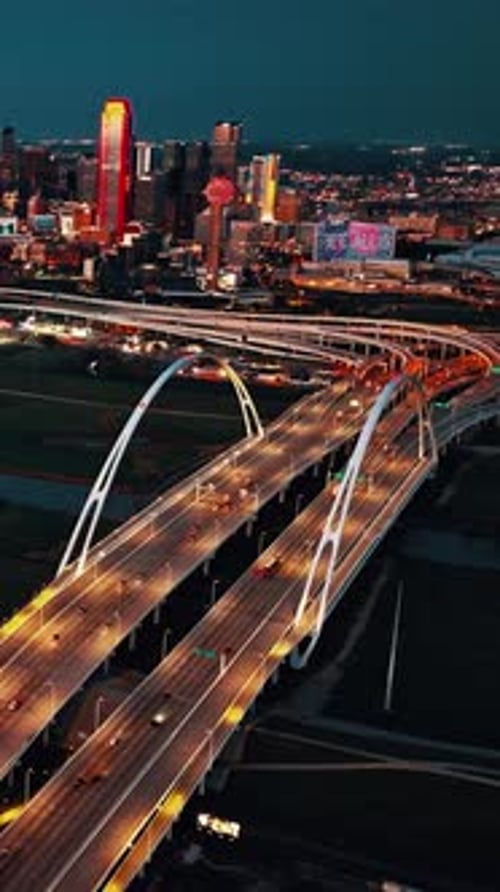 Nighttime aerial view of Dallas showcasing vibrant city lights and highways