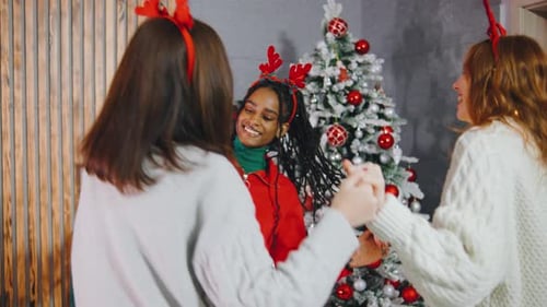Smiling Friends Dance by Christmas Tree