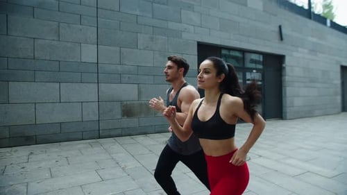 Sporty Couple Running Outdoor Together. Young Man And Woman Training Run On Outdoor Workout. Fitn...