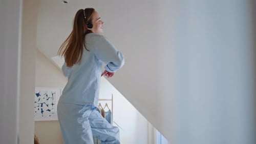 Woman Dancing with Headphones in Home