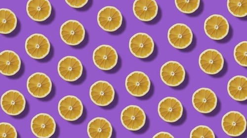 Orange Fruit Slices Rotating on a Purple Background