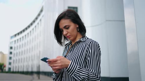 Woman Using Smartphone in Urban Environment