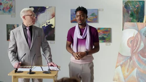 Men Presenting Art at a Press Conference