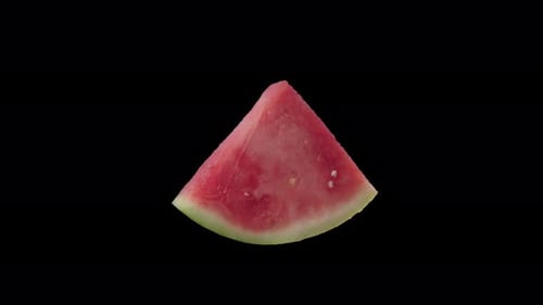 Rotating Slice of Watermelon Isolated on Black Background