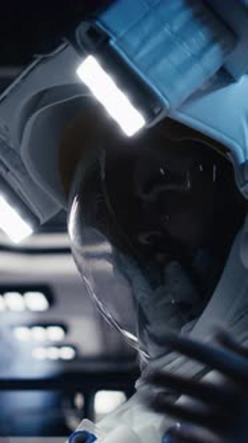 Vertical Video Astronaut Looking at Planet Visualization Before Stepping Out of Space Station