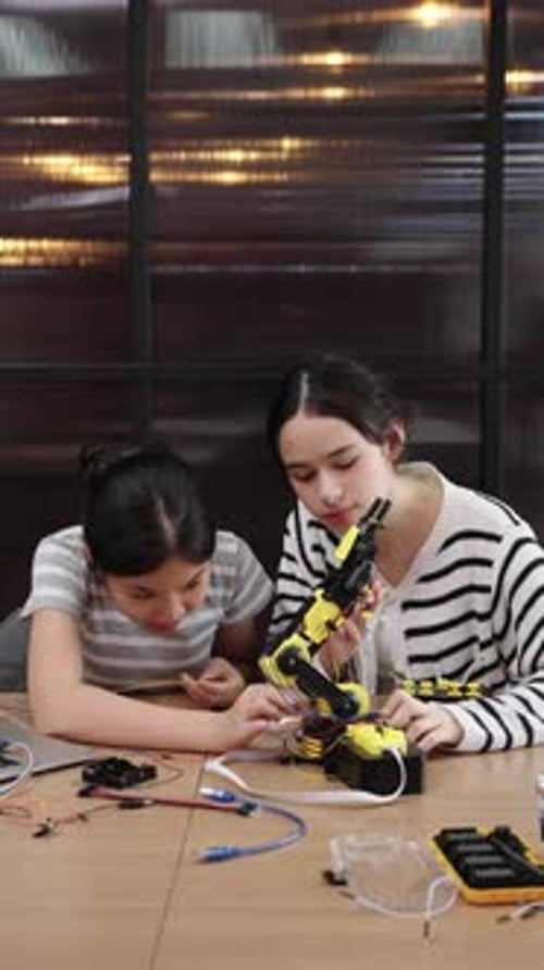 Girls Building Robotics Project Together at Home