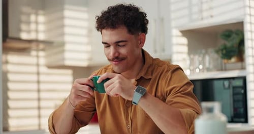Man Enjoys a Cup of Coffee in Kitchen