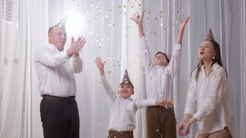 Happy Family Celebrates Birthday with Confetti
