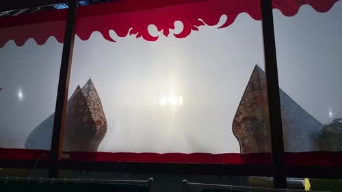 Silhouette of wayang kulit or shadow puppets from Java, Indonesia puppet show by puppeteer