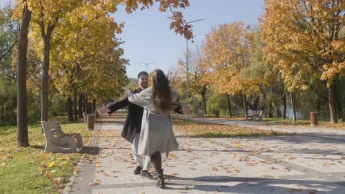 Woman Runs to Man for an Autumn Embrace