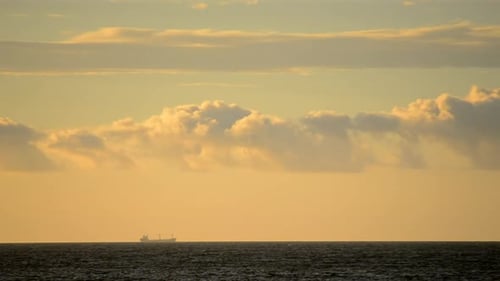 Cargo Ship on the Sea at Sunrise or Sunset