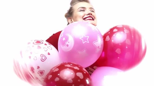 Joyful Woman Smiling with Pink and Red Balloons