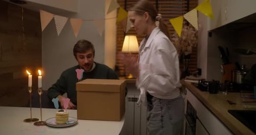 Excited Couple Celebrates Pink Gender Reveal at Home