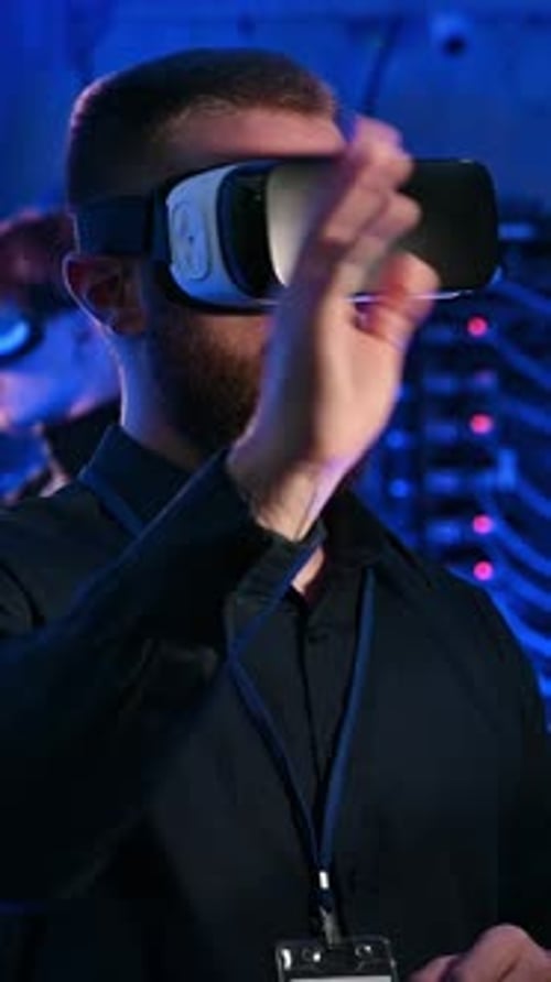Man using Virtual Reality headset in a server room. Vertical