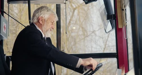 Older Man Driving Bus in the City